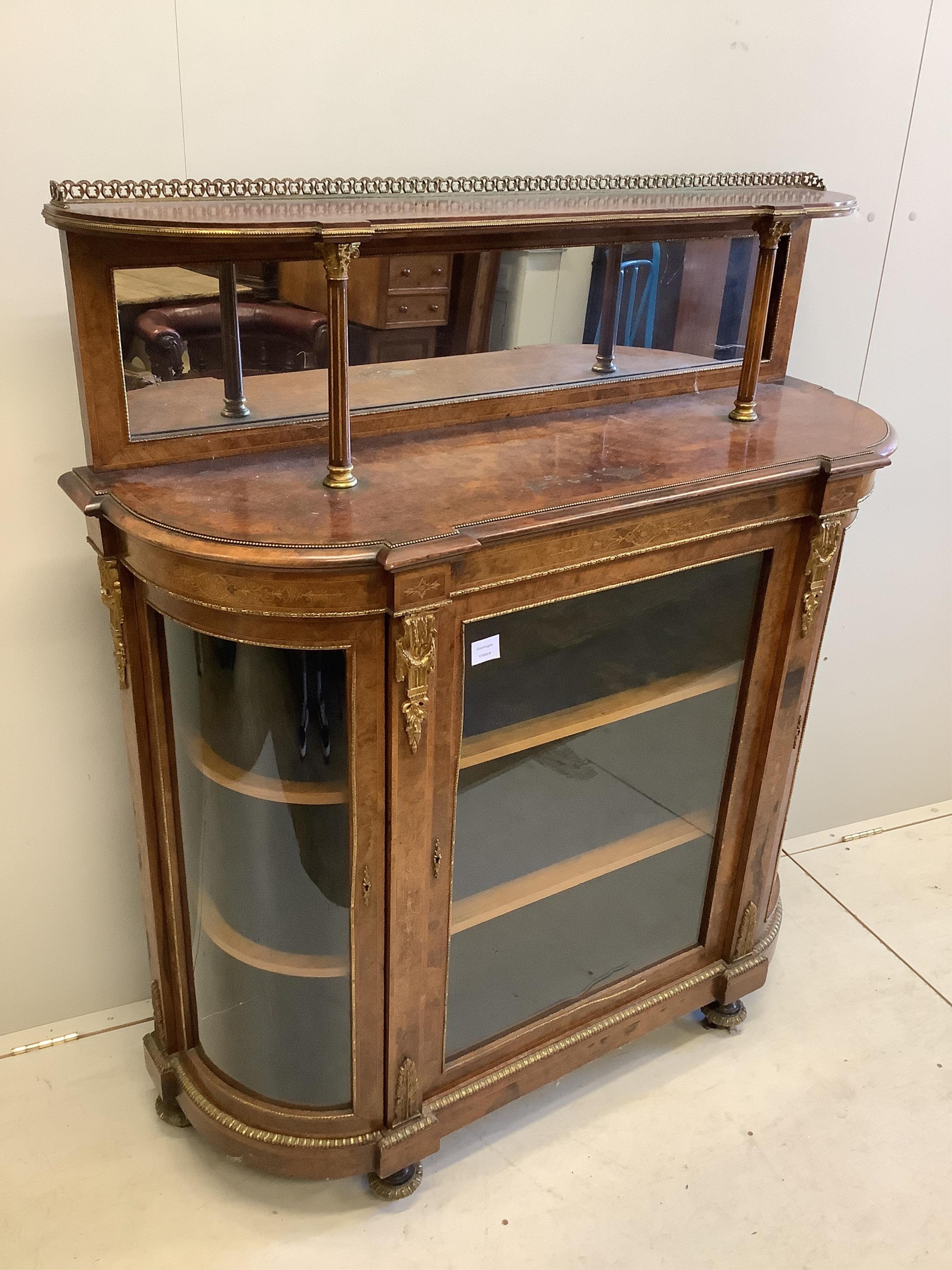 A Victorian gilt metal mounted burr walnut bowfront side cabinet, with mirrored tier back, width 125cm, depth 42cm, height 140cm